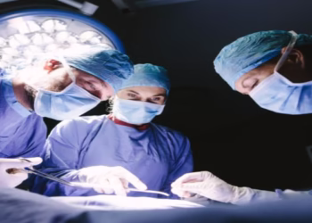 Group of surgeons doing surgery in hospital operating theater. Medical team doing critical operation.