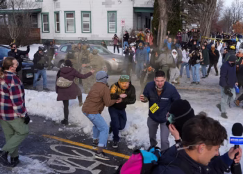 Members of the community and media take cover as Border Patrol agents use chemical irritants to disperse a crowd trying to prevent them from leaving the scene where a driver was shot by a U.S. immigration agent, according to local and federal officials, in Minneapolis, Minnesota, U.S., January 7, 2026. REUTERS/Tim Evans TPX IMAGES OF THE DAY